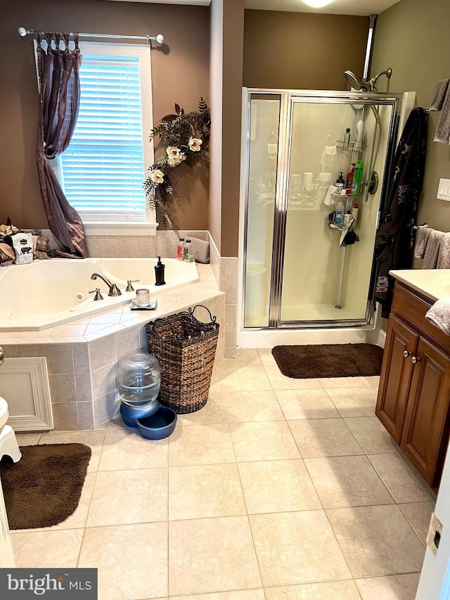 bathroom featuring tile patterned flooring, vanity, and independent shower and bath