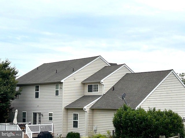 rear view of house with a wooden deck