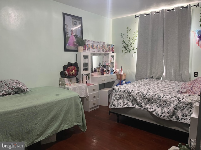 bedroom with dark hardwood / wood-style floors