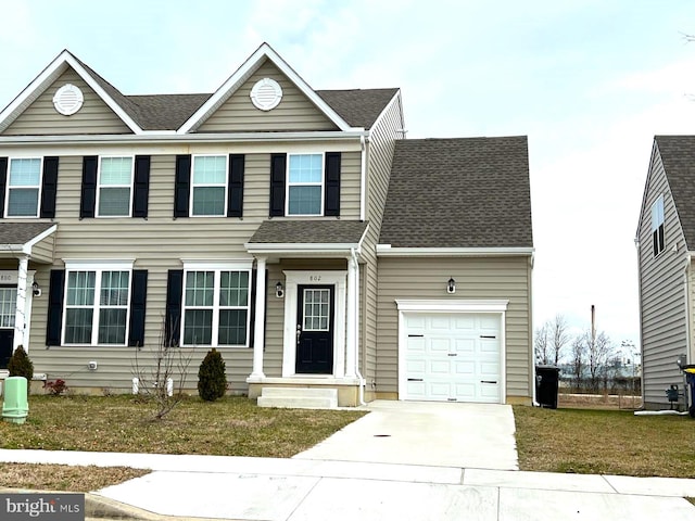 view of front of property featuring a front yard and a garage