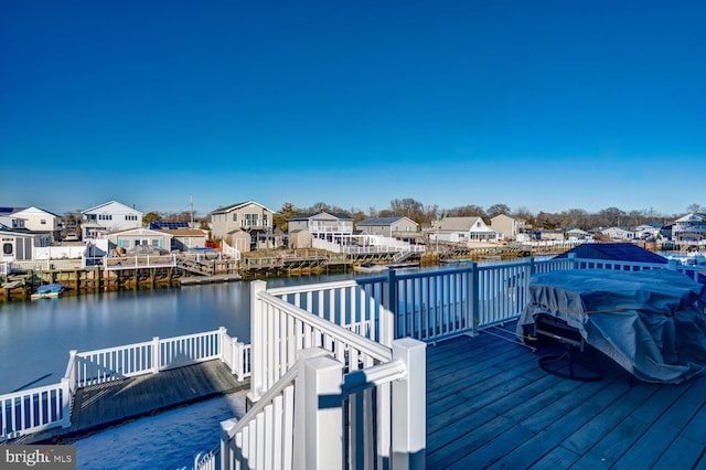 dock area featuring a deck with water view