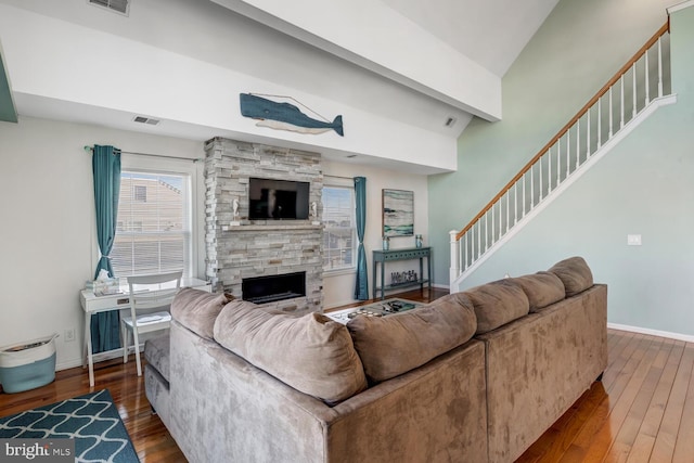 living room with vaulted ceiling, a fireplace, and hardwood / wood-style flooring