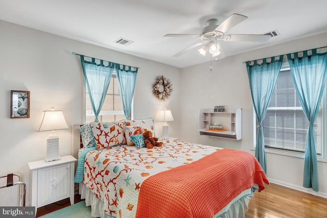 bedroom with ceiling fan and light hardwood / wood-style flooring