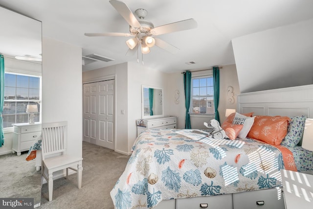 carpeted bedroom featuring ceiling fan and a closet