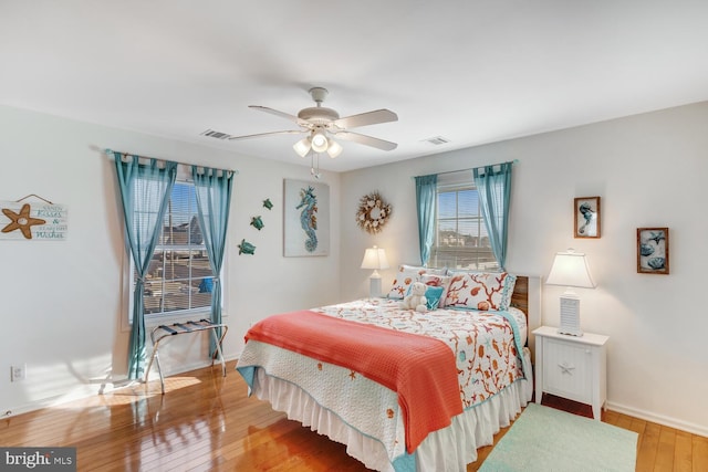 bedroom with ceiling fan and hardwood / wood-style flooring