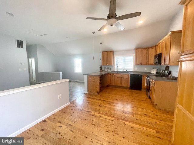 kitchen featuring black appliances, decorative light fixtures, light hardwood / wood-style floors, and vaulted ceiling