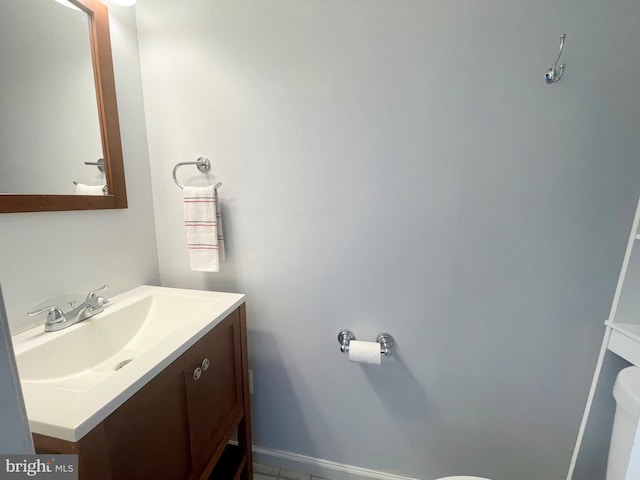 bathroom featuring vanity and toilet