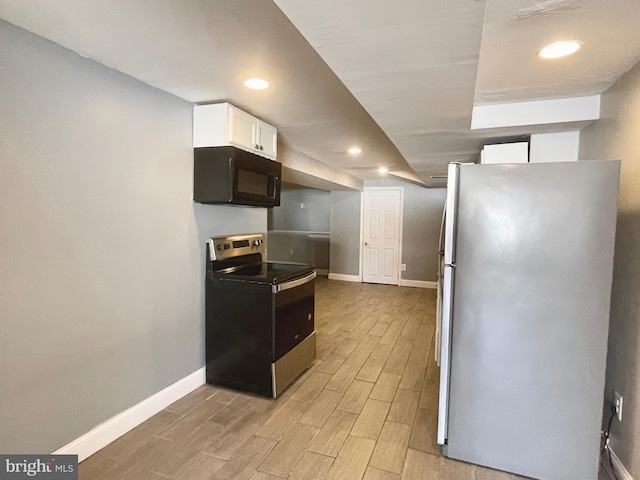 kitchen featuring appliances with stainless steel finishes and white cabinetry