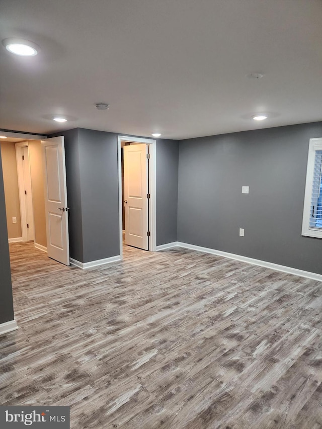 basement with light hardwood / wood-style flooring