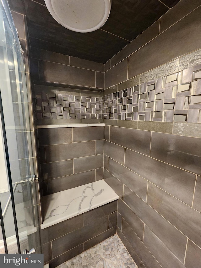 bathroom with a tile shower