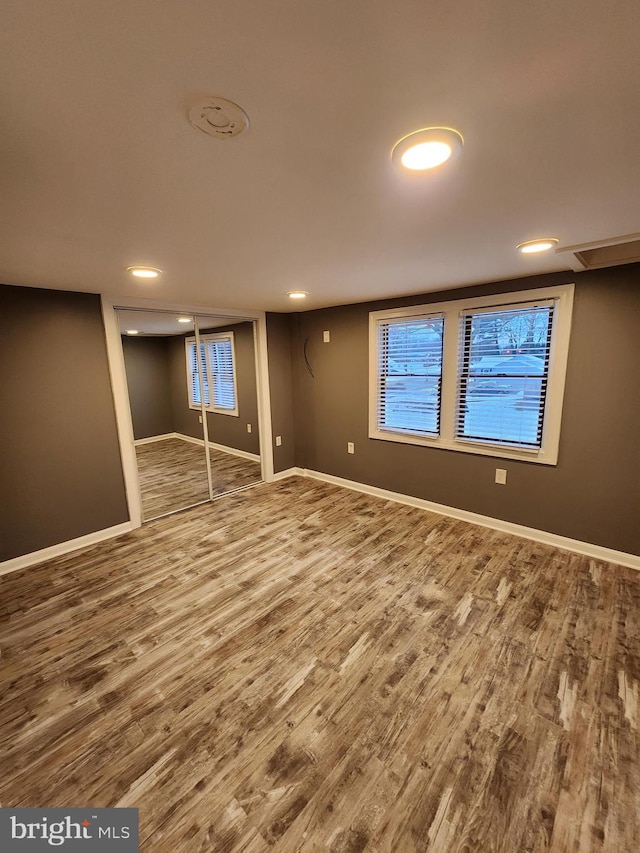 basement with hardwood / wood-style floors