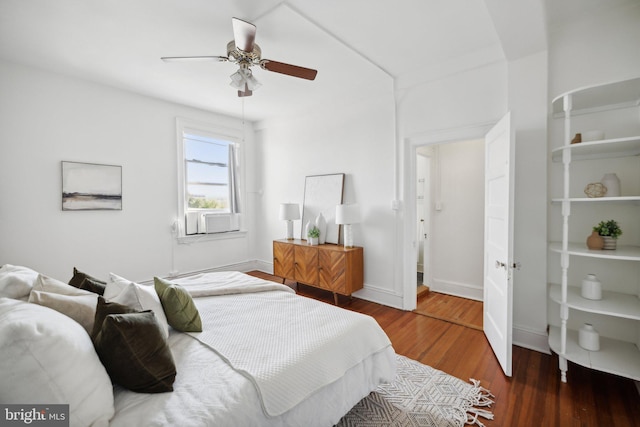 bedroom featuring ceiling fan, cooling unit, and dark hardwood / wood-style floors