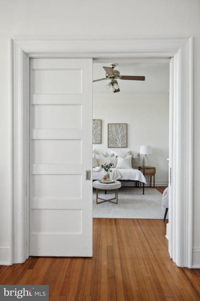 unfurnished bedroom with hardwood / wood-style floors and ceiling fan