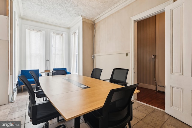 tiled dining area with a textured ceiling, ornamental molding, and a baseboard radiator