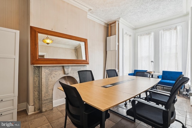 dining room featuring ornamental molding and a textured ceiling