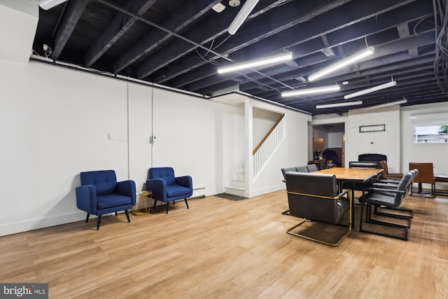 dining area with a baseboard heating unit and wood-type flooring