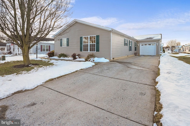 view of snowy exterior featuring a garage