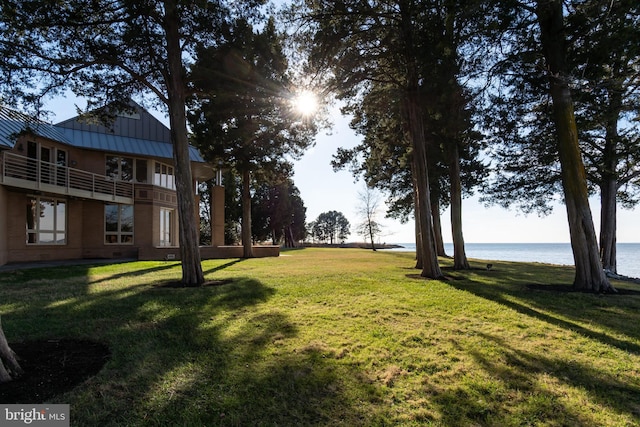 view of yard featuring a water view and a balcony