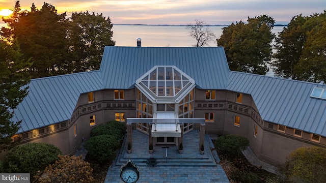 view of back house at dusk