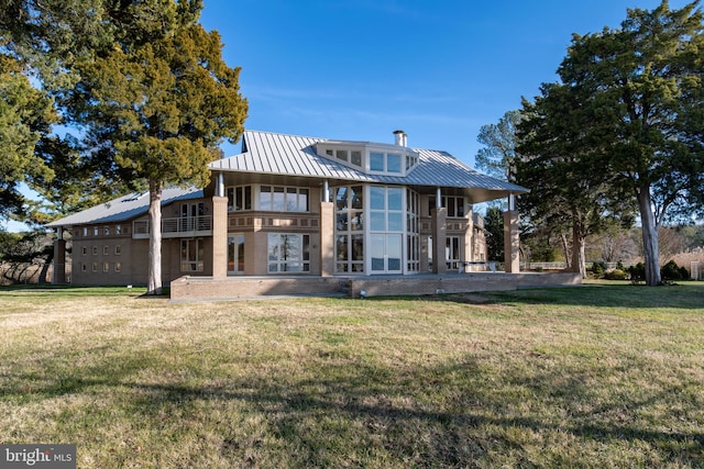 back of house with a lawn