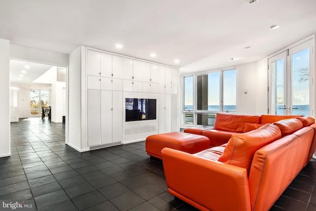 living room with dark tile patterned floors and french doors