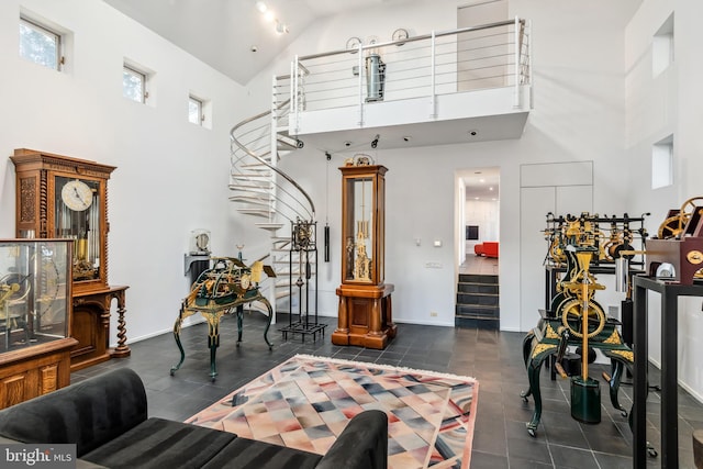 living room with dark tile patterned floors and a high ceiling