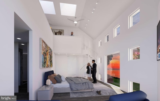 bedroom featuring high vaulted ceiling and multiple windows