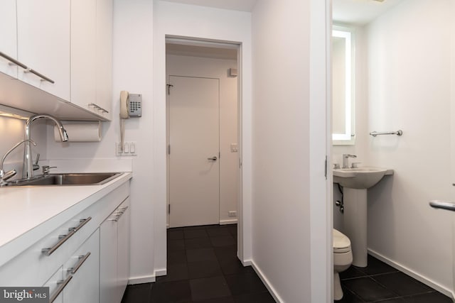 bathroom with tile patterned flooring, toilet, and sink