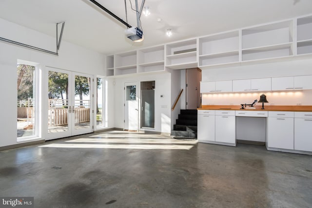 garage with french doors and a garage door opener