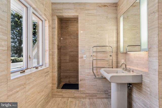 bathroom with walk in shower and tile walls