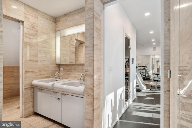 bathroom with tile patterned floors, vanity, and tile walls