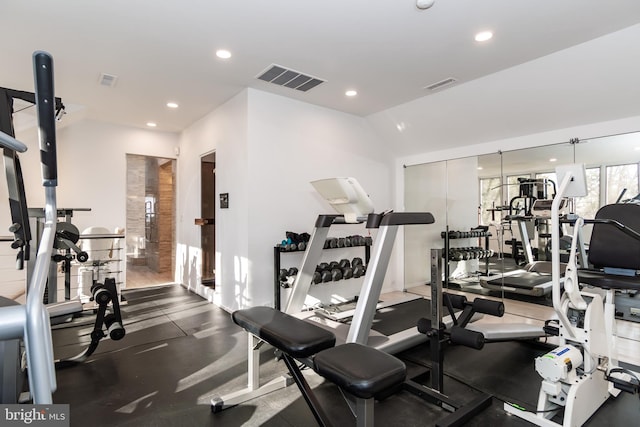 exercise room with vaulted ceiling