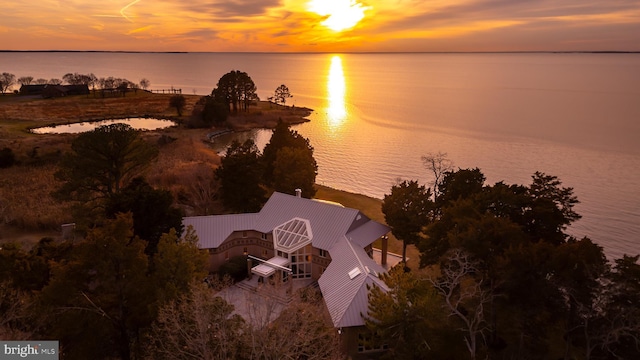 aerial view at dusk with a water view