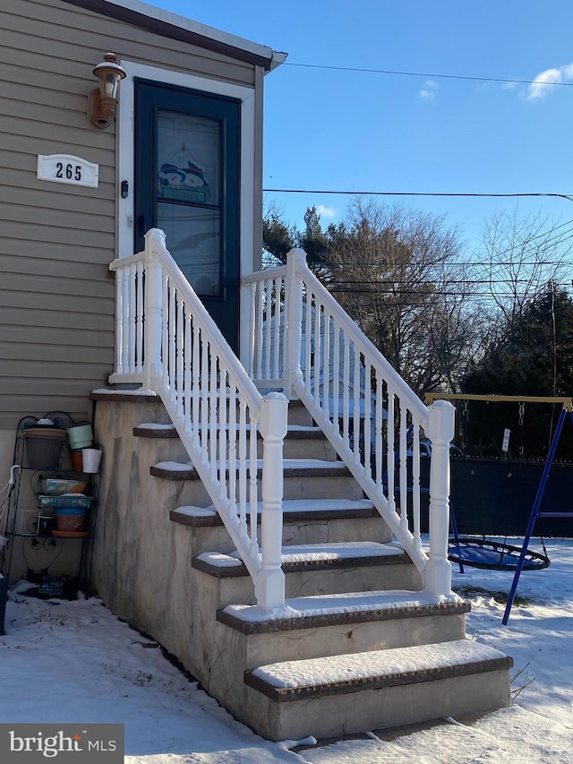 view of snow covered property entrance