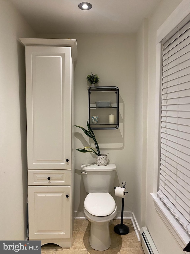 bathroom with toilet and a baseboard heating unit