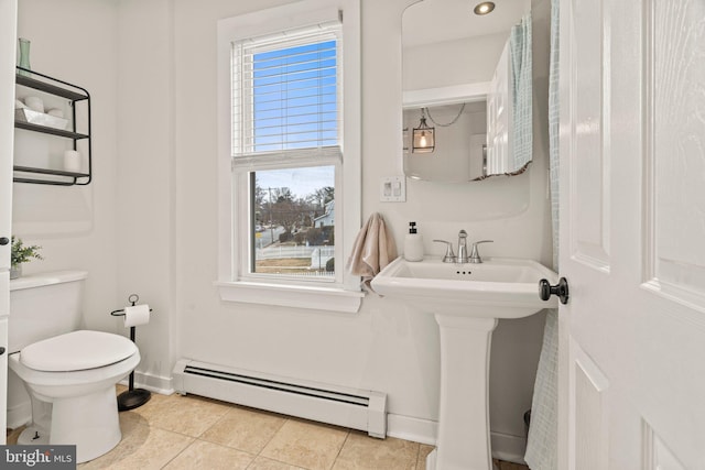 bathroom featuring tile patterned flooring, toilet, and a baseboard radiator