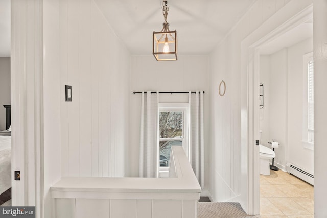 interior space featuring light tile patterned floors and a baseboard heating unit