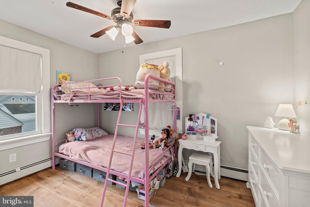 bedroom with hardwood / wood-style flooring, ceiling fan, and a baseboard radiator