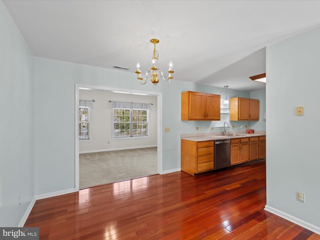 kitchen featuring pendant lighting, an inviting chandelier, sink, stainless steel dishwasher, and dark hardwood / wood-style floors