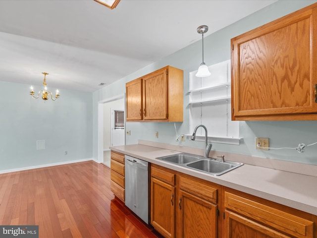 kitchen featuring dark hardwood / wood-style flooring, sink, decorative light fixtures, dishwasher, and a chandelier