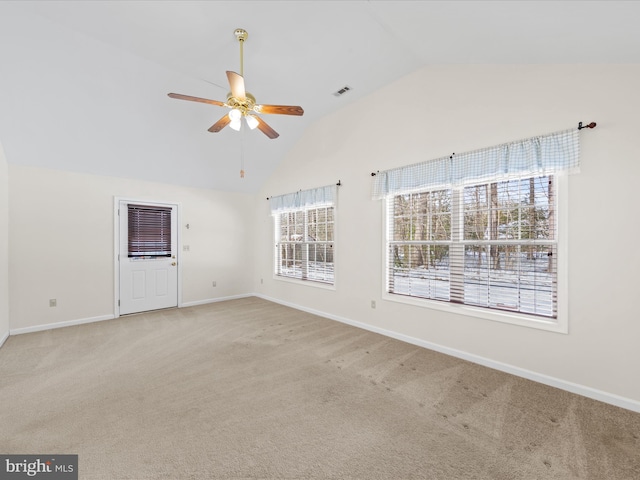 carpeted spare room with ceiling fan and lofted ceiling