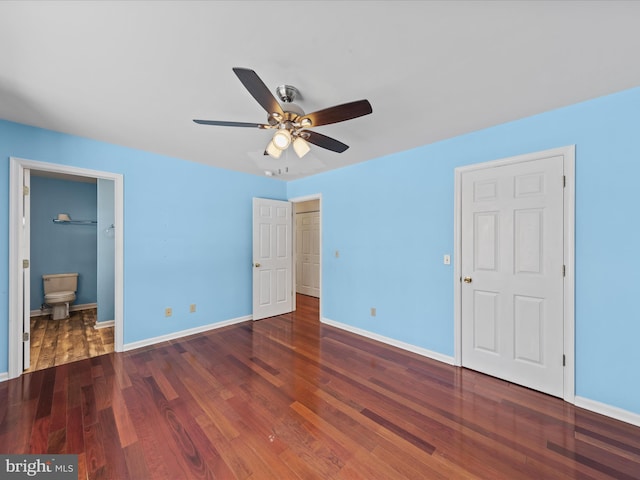 unfurnished bedroom featuring connected bathroom, ceiling fan, and dark hardwood / wood-style floors