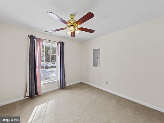 carpeted empty room with ceiling fan and electric panel