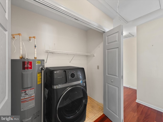 clothes washing area featuring washer / clothes dryer and water heater