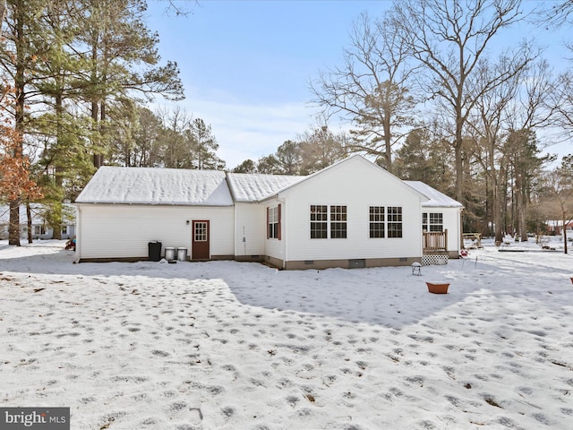 view of snow covered back of property