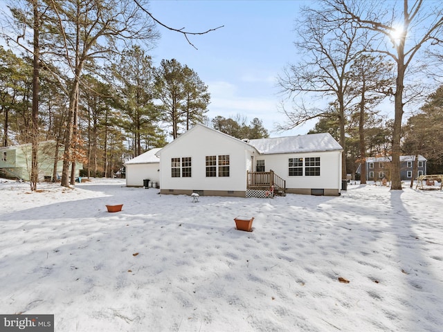 view of snow covered rear of property