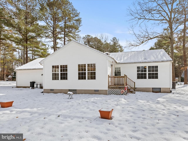 snow covered house with central air condition unit