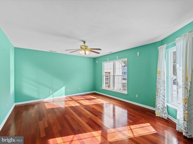 spare room with ceiling fan and dark wood-type flooring