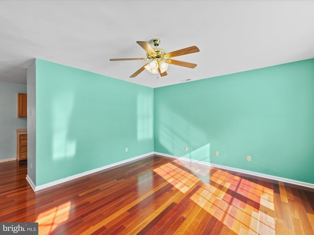 empty room featuring hardwood / wood-style floors and ceiling fan