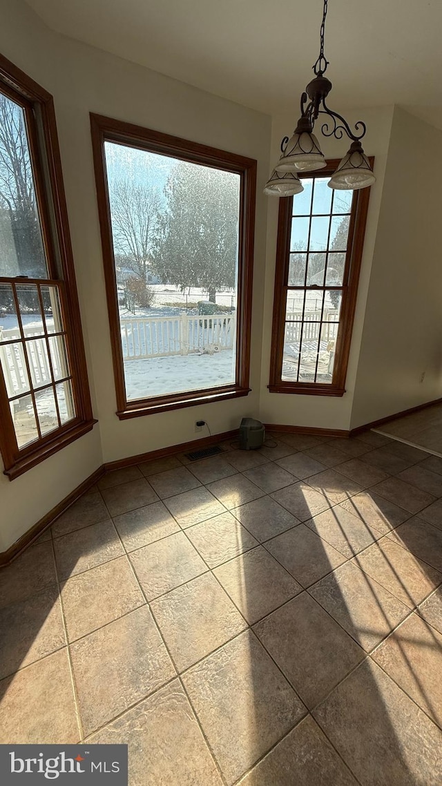 unfurnished dining area with tile patterned flooring